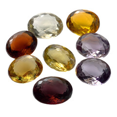 Collection of polished oval cut gemstones with varying colors isolated on transparent background