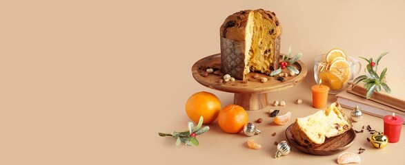 Cut Panettone and Christmas decor on beige background with space for text