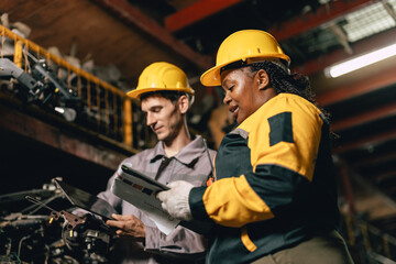 African women with engineer man staff worker working heavy industry old part warehouse
