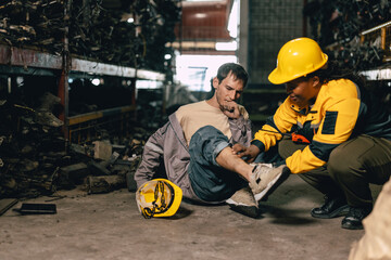 Supervisor working medical emergency first aid help employee staff accident at workplace, leg injury