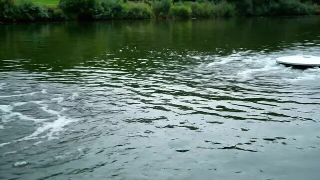 Aerator Floating on Calm Pond Water near Green Foliage and Ripple Effect to Enhance Oxygen Levels in Environmental Conservation and Water Management Systems for Advertisements 199 chars