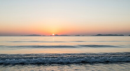 Tranquil seascape at dawn with rising sun over calm ocean waves and distant islands