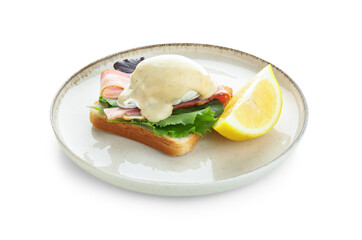 Plate with tasty egg Benedict and lemon slice on white background