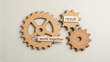 Three cardboard gears representing work and collaboration for a result