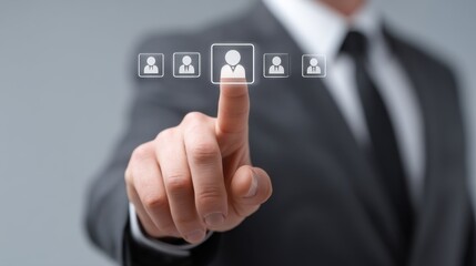 Obraz premium Businessman Selecting Professional Profile Icons on Virtual Interface in Modern Corporate Setting for Recruitment or Talent Acquisition Concept