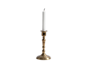 Candle in vintage brass candlestick, black background