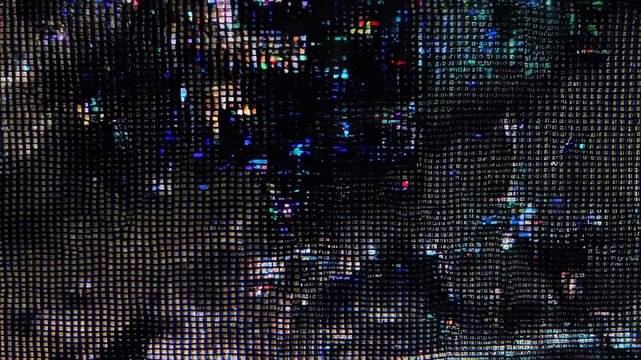 An abstract image of colored, pixelated lights filtered through a dark, grid-like pattern