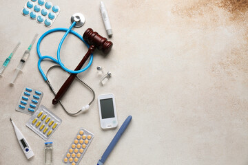 Judge gavel, different medicine and stethoscope on white grunge background. Concept of health care...