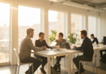Blurred view of a business team meeting in a sunlit modern office.