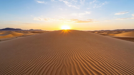 Golden sand dunes stretch under vibrant sunset, creating serene desert landscape