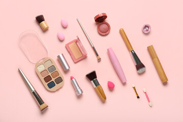 Composition with makeup brushes and cosmetic products on pink background