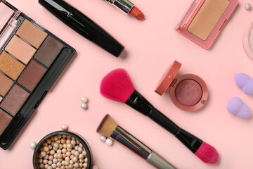 Composition with different makeup brushes and cosmetic products on pink background, closeup