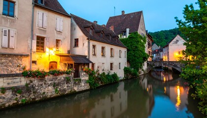 Picturesque European Townscape along a Gentle Canal at Dusk