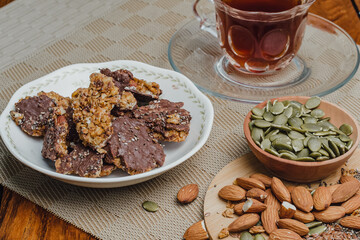 Crunchy chocolate granola with almonds on rustic table.