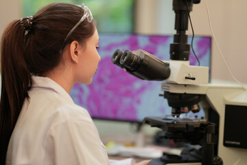 A biomedical researcher uses an AI-powered platform to analyze complex genomic data, identifying a novel biomarker for personalized medicine and accelerating future drug discovery.