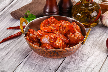 Raw marinated buffalo chicken wings