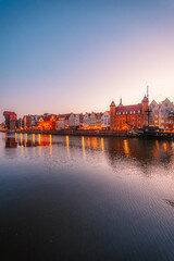 Fototapeta premium Gdansk with Motlawa river in Poland. Old town colourful house with Stragania Gate