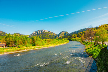 Peak Tri Koruny or Trzy Korony during day with green meadow and trees in spring. Pieniny National park in Slovakia and Poland