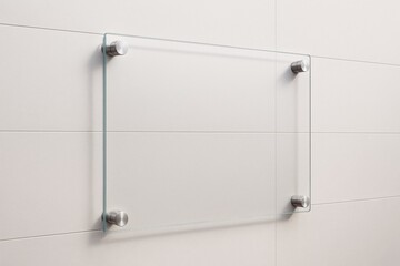 Transparent glass signboard mounted on tiled wall with metallic holders in minimal clean style for modern advertising or branding mockup template.