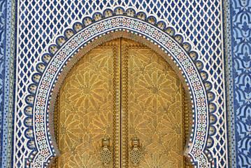 Brass door with Arabic calligraphy and Moroccan zellij mosaic tilework. Royal Palace, Fez, Morocco