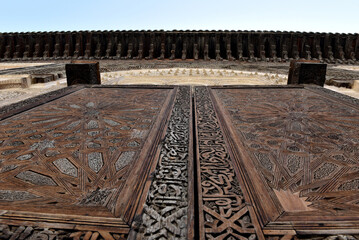 Carved wooden door details with geometric patterns, Bou Inania Madrasa. Fez, Morocco