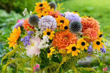 Summer bouquet. Beautiful orange, yellow and blue fresh flower arrangement. Birthday or weddding bouquet made of summer flowers.