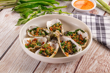 Gournet grilled oysters with onion and peanut