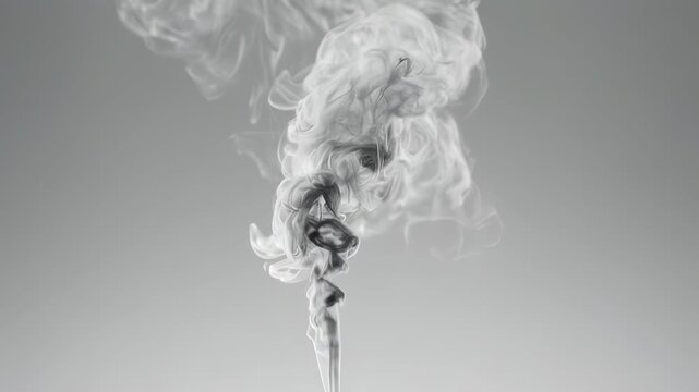 An abstract grey-scale image showcasing swirls of smoke rising against a plain, light-grey background