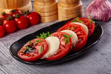 Italian caprese salad with mozzarella, tomato and basil