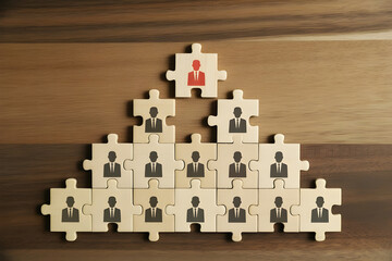 Fototapeta premium Puzzle Pyramid with Red Leader Piece – Concept of Leadership and Teamwork