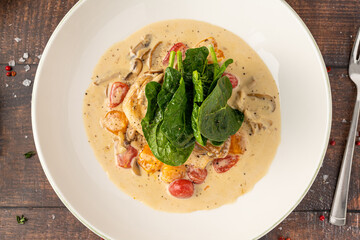 Tender chicken breast in creamy sauce with cherry tomatoes and spinach