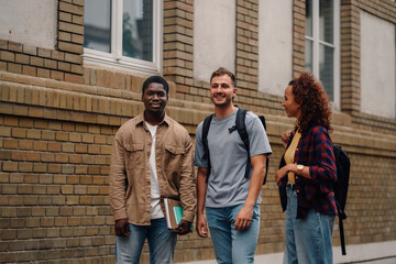 Fototapeta premium University students walking and talking together on campus