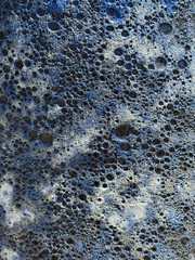 Abstract background of bubble frothy blue gray surface.