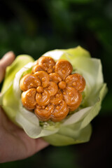 A mooncake wrapped in lotus flower
