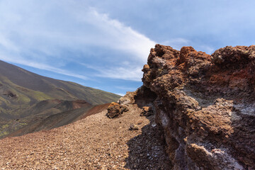 Dramatic volcanic landscape featuring rocky foreground