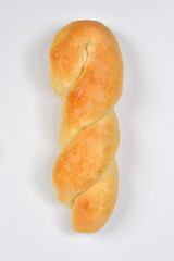 An overhead studio shot features a single, freshly baked, golden-brown twisted breadstick or knot, isolated on a clean white background