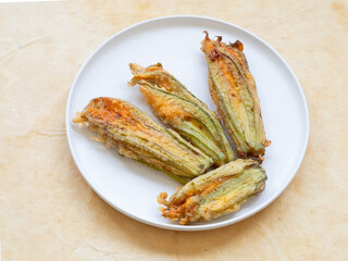 Fried stuffed zucchini flowers preparing traditional italian appetizer