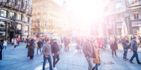 Crowd of anonymous people walking on busy city