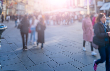 Crowd of anonymous people walking on busy city
