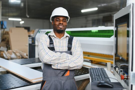 African american Furniture maker smiling with confidence in his workshop - Powered by Adobe