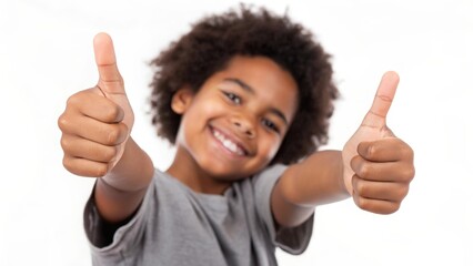 Child gives thumbs up sign against white background smiling happily in casual clothing