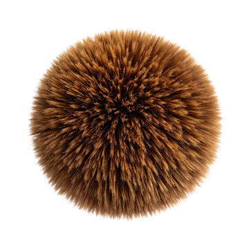 Close-up, top-down view of a fluffy, spherical, brown fur ball against a stark black backdrop