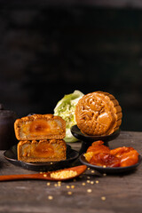 Assorted traditional mooncakes on wooden table, Mid-Autumn festival dessert