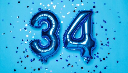 Blue balloon number 34 with confetti on solid colored background. Photo for anniversary or birthday party