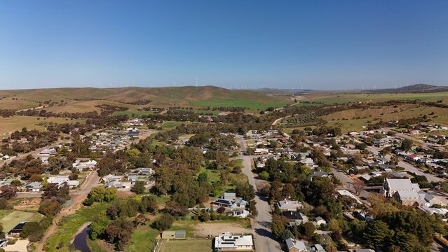 Burra, South Australia &ndash; Aerial Drone Image of Historic Pastoral Town, Country Houses, Estates, Streets, Canola Fields, and Wind Turbines in the Mid-North Agricultural Region