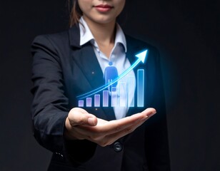 Businesswoman holding a glowing holographic upward chart, representing growth and success, against a dark backdrop
