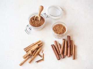 Cinnamon powder in jars and ceylon cassia sticks