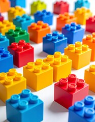 Obraz premium Close-up of Colorful Plastic Building Blocks on a White Background, Education and STEM Concept