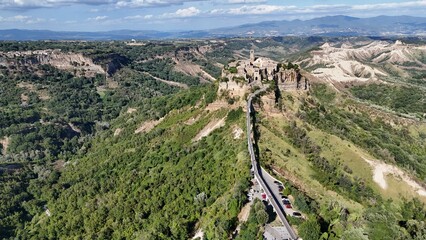 Aerial drone footage of Civita di Bagnoregio, the famous ‘dying town’ in Lazio, perched on a hilltop with dramatic surrounding valleys.