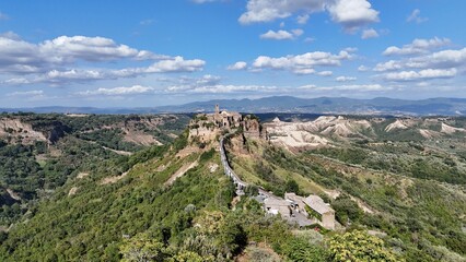 Aerial drone footage of Civita di Bagnoregio, the famous ‘dying town’ in Lazio, perched on a hilltop with dramatic surrounding valleys.